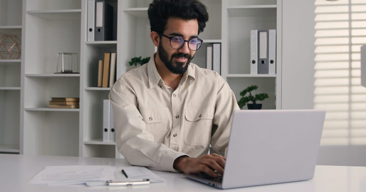 An aspirant checking exam notification dates on a laptop
