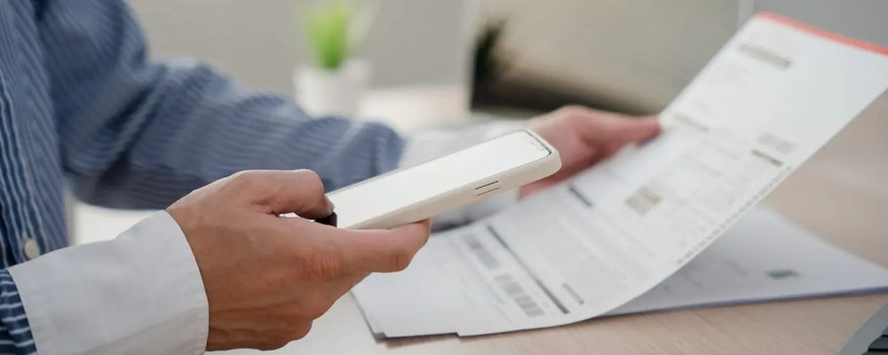 Scanning a printed practice paper with a phone to review attempts